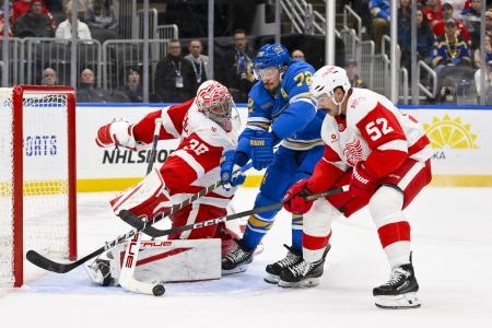 Oct 28, 2025; St. Louis, Missouri, USA; Detroit Red Wings goaltender John Gibson (36) and defenseman Travis Hamonic (52) defend the net against St. Louis Blues defenseman Justin Faulk (72) during the second period at Enterprise Center. Mandatory Credit: Jeff Curry-Imagn Images
