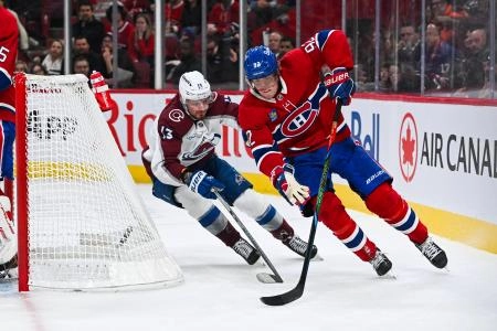 Mar 22, 2025; Montreal, Quebec, CAN; Montreal Canadiens right wing Patrik Laine (92) defends the puck against Colorado Avalanche right wing Valeri Nichushkin (13) behind the net in the second period at Bell Centre. Mandatory Credit: David Kirouac-Imagn Images