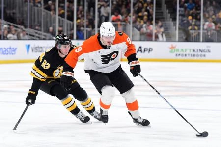 Jan 29, 2026; Boston, Massachusetts, USA; Philadelphia Flyers defenseman Jamie Drysdale (9) controls the puck from Boston Bruins center Fraser Minten (93) during the second period at TD Garden. Mandatory Credit: Bob DeChiara-Imagn Images