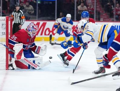 Jan 22, 2026; Montreal, Quebec, CAN; Montreal Canadiens goalie Sam Montembeault (35) stops Buffalo Sabres forward Jack Quinn (22) during the second period at the Bell Centre. Mandatory Credit: Eric Bolte-Imagn Images