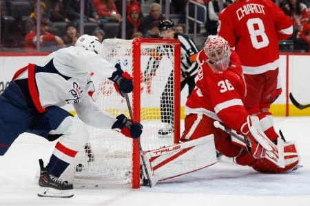 Jan 29, 2026; Detroit, Michigan, USA; Washington Capitals center Dylan Strome (17) scores on Detroit Red Wings goaltender John Gibson (36) in the third period at Little Caesars Arena. Mandatory Credit: Rick Osentoski-Imagn Images