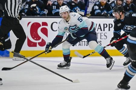 Jan 17, 2026; Salt Lake City, Utah, USA; Seattle Kraken center Shane Wright (51) lines up his shot around Utah Mammoth defenseman Nick DeSimone (57) during first period at Delta Center.