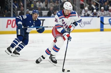 Oct 16, 2025; Toronto, Ontario, CAN; New York Rangers forward Artemi Panarin (10) skates the puck away from Toronto Maple Leafs forward Nick Robertson (89) in the first period at Scotiabank Arena. Mandatory Credit: Dan Hamilton-Imagn Images