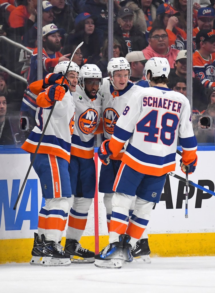 Calum Ritchie #64, Anthony Duclair #11, Mathew Barzal #13 and Matthew Schaefer #48 of the New York Islanders celebrate a third-period goal against the Edmonton Oilers during the game at Rogers Place on January 15, 2026.