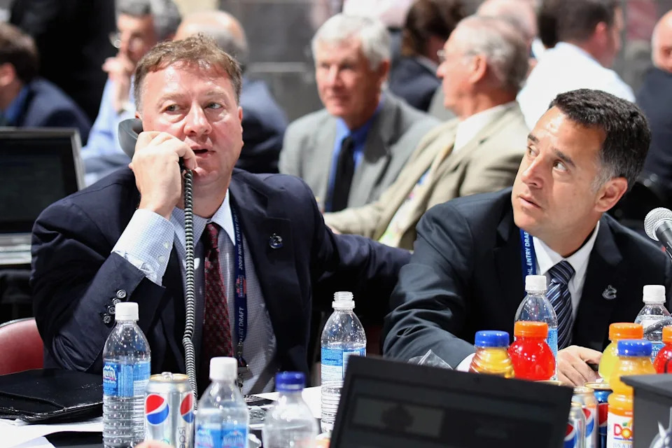 MONTREAL, QC - JUNE 27: (L-R) General Manager Mike Gillis and assistant General Manager Laurence Gilman of the Vancouver Canucks sit at the draft table during the 2009 NHL Entry Draft at the Bell Centre on June 27, 2009 in Montreal, Quebec, Canada. (Photo by Bruce Bennett/Getty Images)