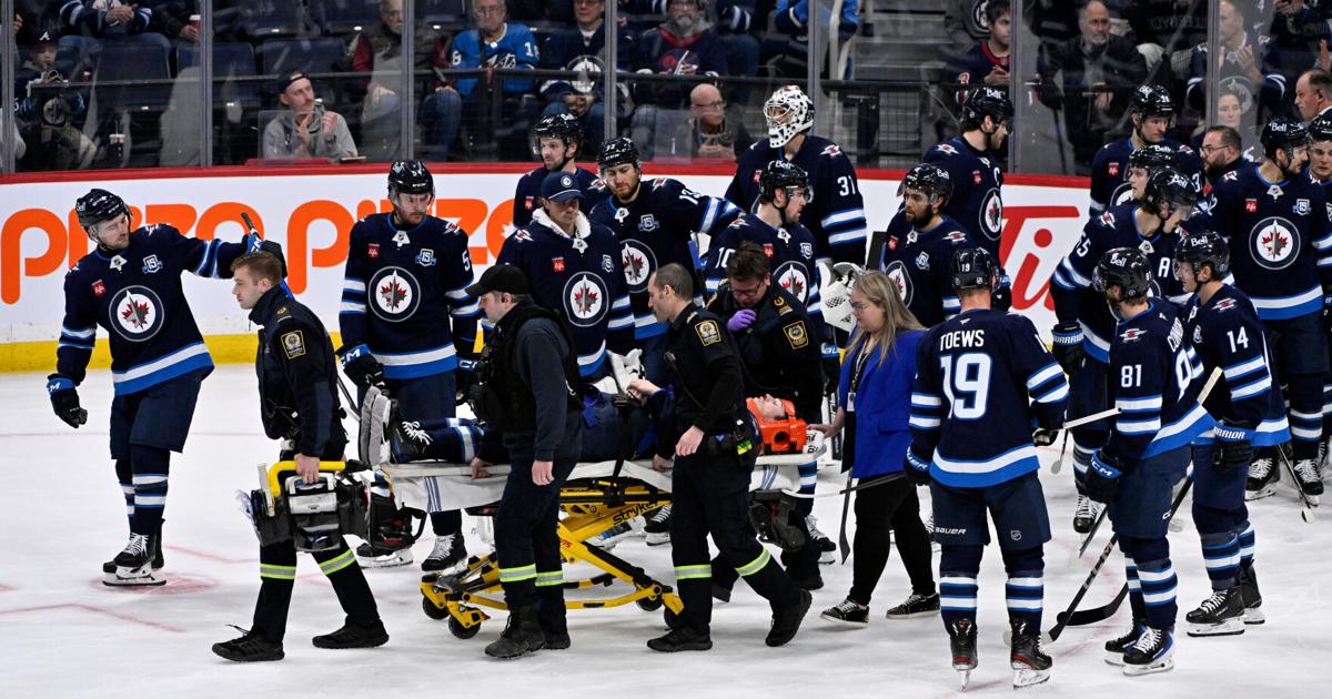 Jets D Fleury alert, moving extremities after taken off ice on stretcher after collision with boards | Pro National Sports