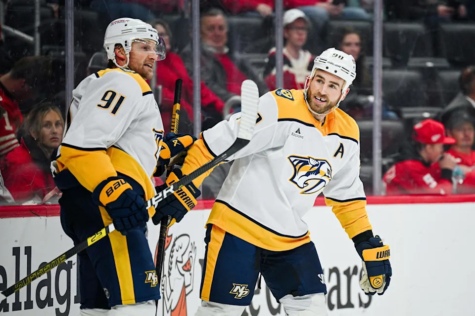 Nov 26, 2025; Detroit, Michigan, USA; Nashville Predators center Ryan O'Reilly (90) celebrates his goal with center Steven Stamkos (91) during the third period against the Detroit Red Wings at Little Caesars Arena. Mandatory Credit: Tim Fuller-Imagn Images