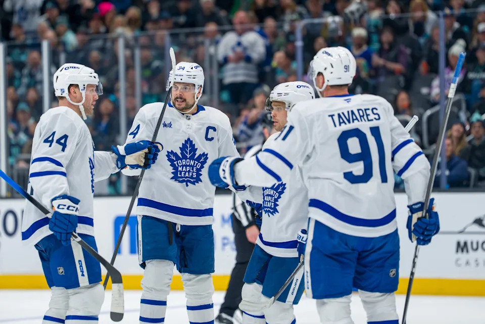 Toronto Maple Leafs, from left, defenseman Morgan Rielly (44), forward Auston Matthews (34), forward and others celebrate a goal.Stephen Brashear-Imagn Images