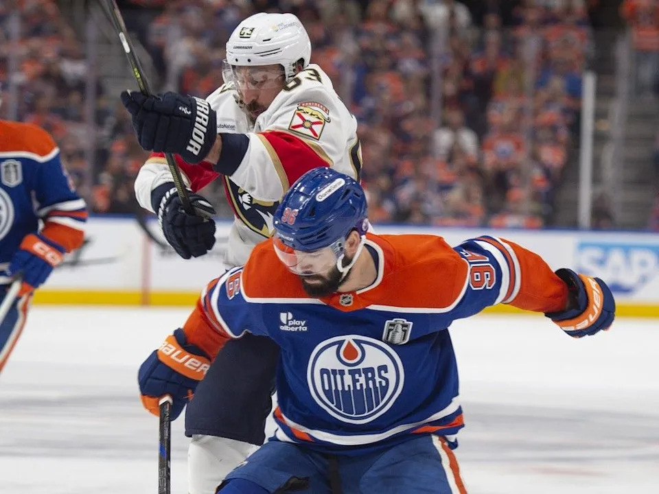  Jake Walman (96) of the Edmonton Oilers, checks Brad Marchant (63) of the Florida Panthers in game five of the Stanley Cup final at Rogers Place in Edmonton on June 14, 2025.