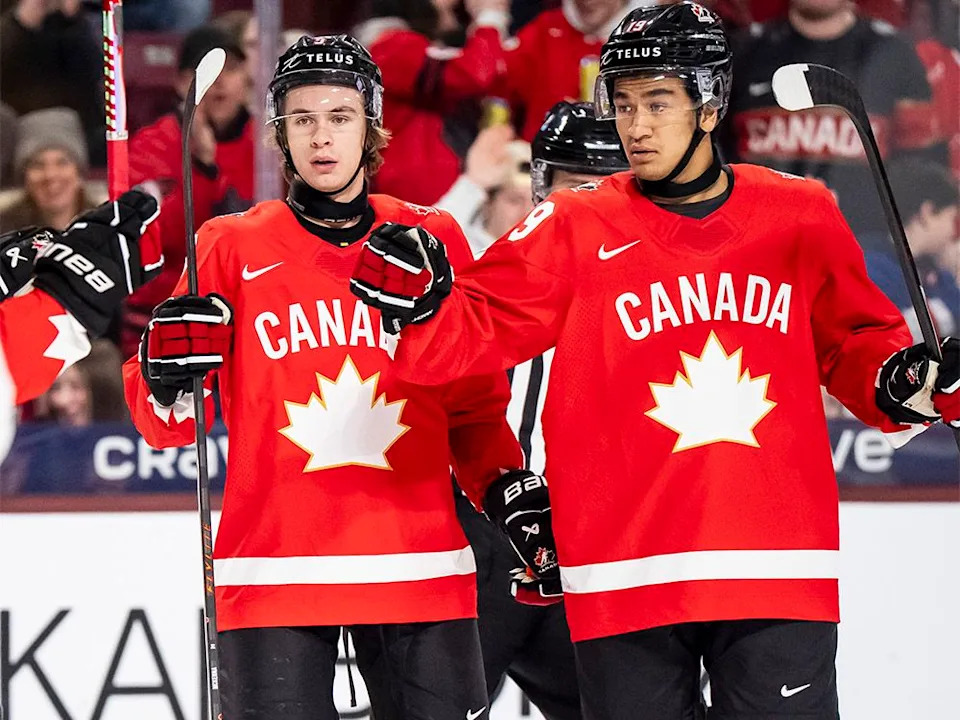  Canada’s Zayne Parekh (19) celebrates his goal with teammates Gavin McKenna (9) and Cole Reschny (21) after scoring during first-period IIHF World Junior Championship hockey action against Denmark in Minneapolis on Monday, Dec. 29, 2025.