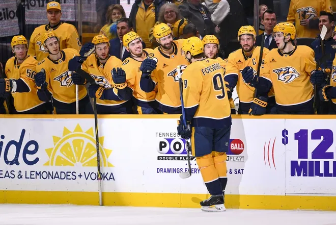 Jan 8, 2026; Nashville, Tennessee, USA; Nashville Predators left wing Filip Forsberg (9) celebrates with his teammates after scoring a goal during the shootout period against the New York Islanders at Bridgestone Arena.
