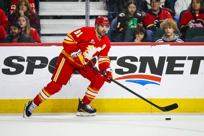 Jan 19, 2026; Calgary, Alberta, CAN; Calgary Flames center Nazem Kadri (91) controls the puck against the New Jersey Devils during the second period at Scotiabank Saddledome.