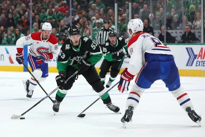  Wyatt Johnston (#53) of the Dallas Stars skates with the puck in front of Mike Matheson of the Montreal Canadiens during the third period at American Airlines Center on Sunday, January 4, 2026 in Dallas, Texas.