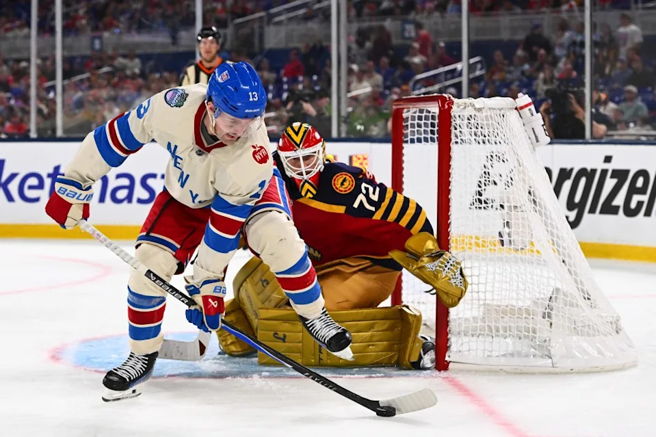 Alexis Lafreniere of the New York Rangers controls the puck in front of Sergei Bobrovsky of the Florida Panthers during the third period of the 2026 Discover NHL Winter Classic game at loanDepot park on January 2, 2026. NHLI via Getty Images
