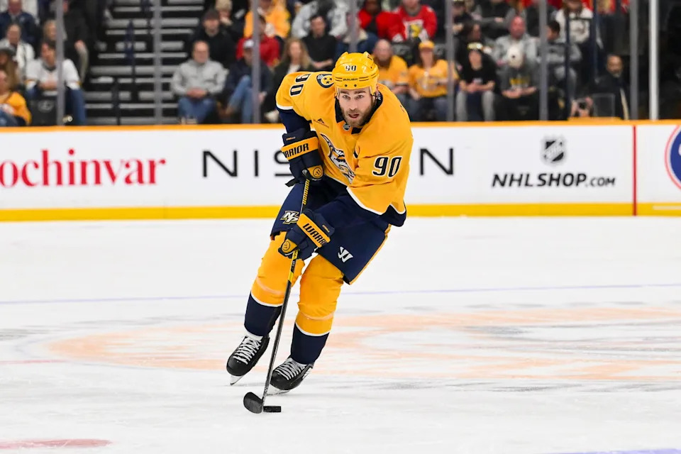 Jan 10, 2026; Nashville, Tennessee, USA; Nashville Predators center Ryan O'Reilly (90) skates with the puck against the Chicago Blackhawks during the third period at Bridgestone Arena. Mandatory Credit: Steve Roberts-Imagn Images