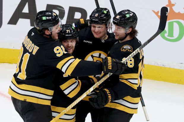 Boston Bruins left wing Viktor Arvidsson (71) and teammates celebrate after his goal during the first period of an NHL game against the Pittsburgh Penguins, Sunday, Jan. 11, 2026, in Boston. (AP Photo/Mark Stockwell)