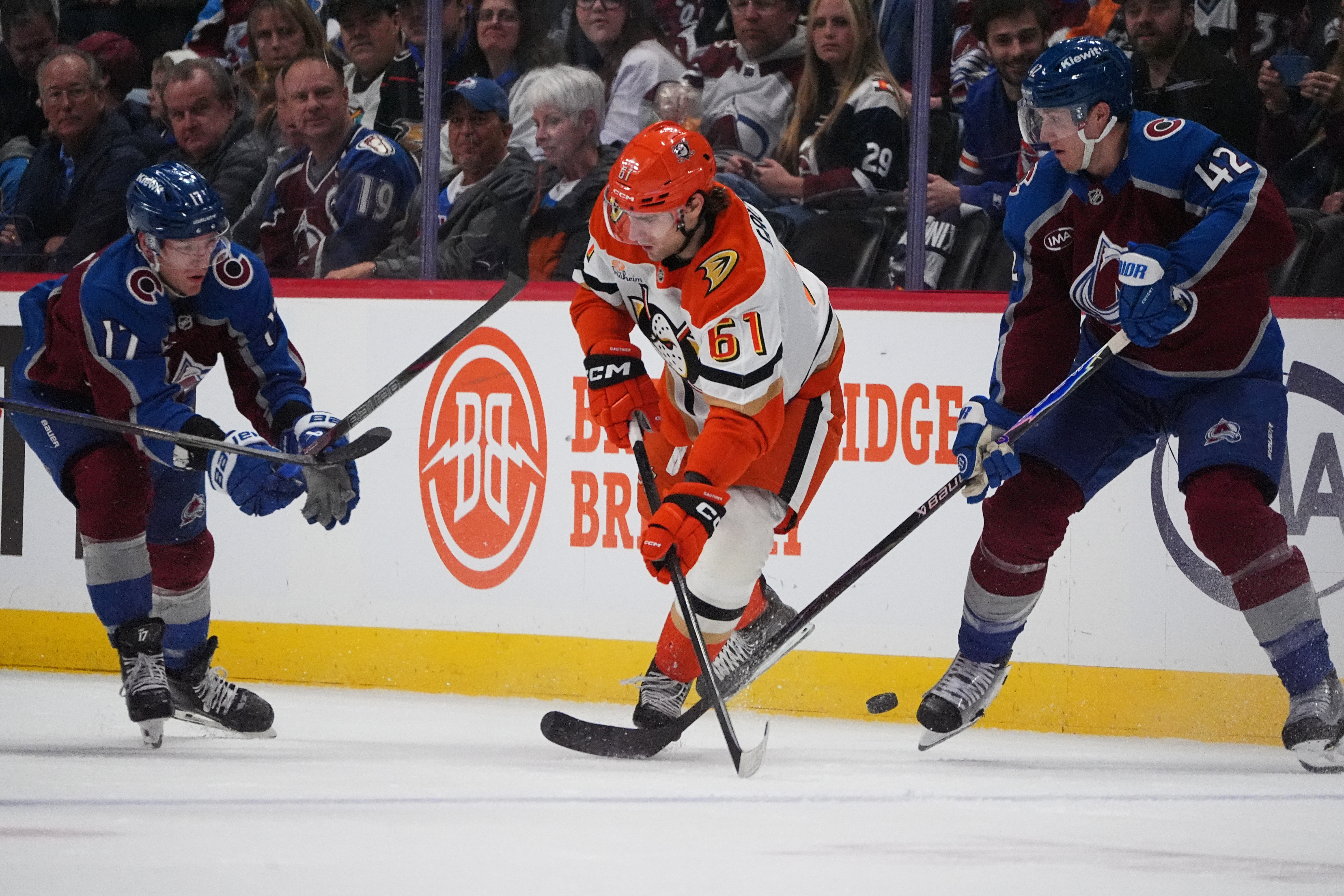 Ducks left wing Cutter Gauthier, center, passes the puck while...