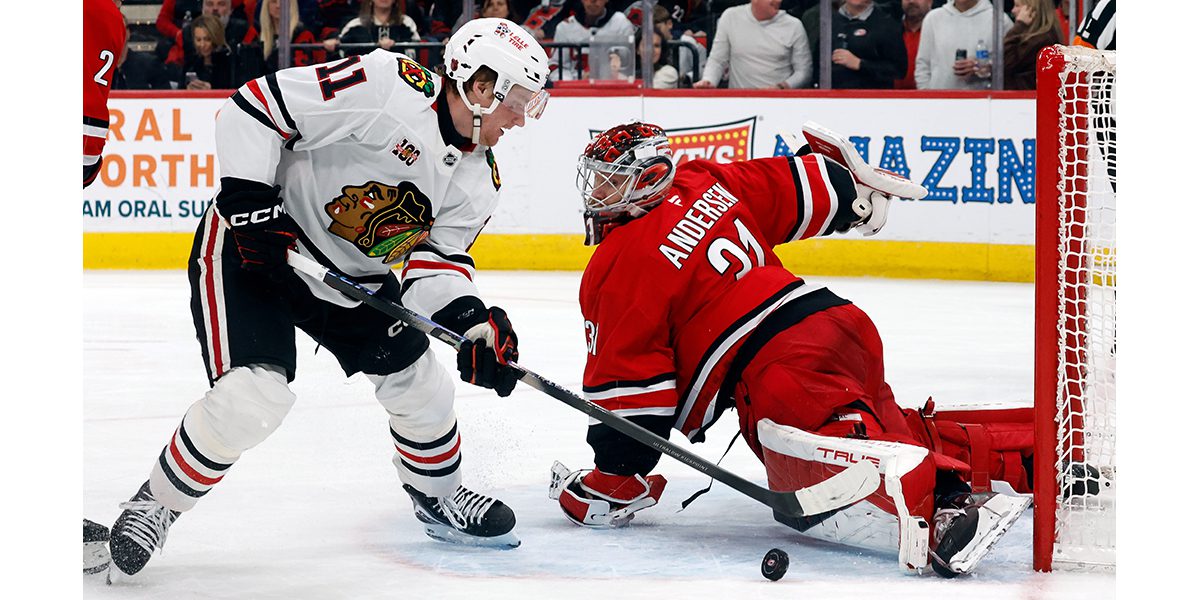 Moore gets off mat, lifts Blackhawks past Hurricanes in shootout