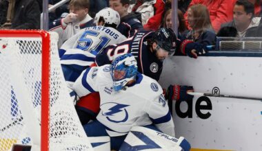 Tampa Bay Lightning's Jonas Johansson, front, gets caught up behind the net as teammate Charle-Edouard D'Astous, left, and Columbus Blue Jackets' Adam Fantilli fight for the puck during the first period of an NHL hockey game, Saturday, Jan. 24, 2026, in Columbus, Ohio. (AP Photo/Jay LaPrete)