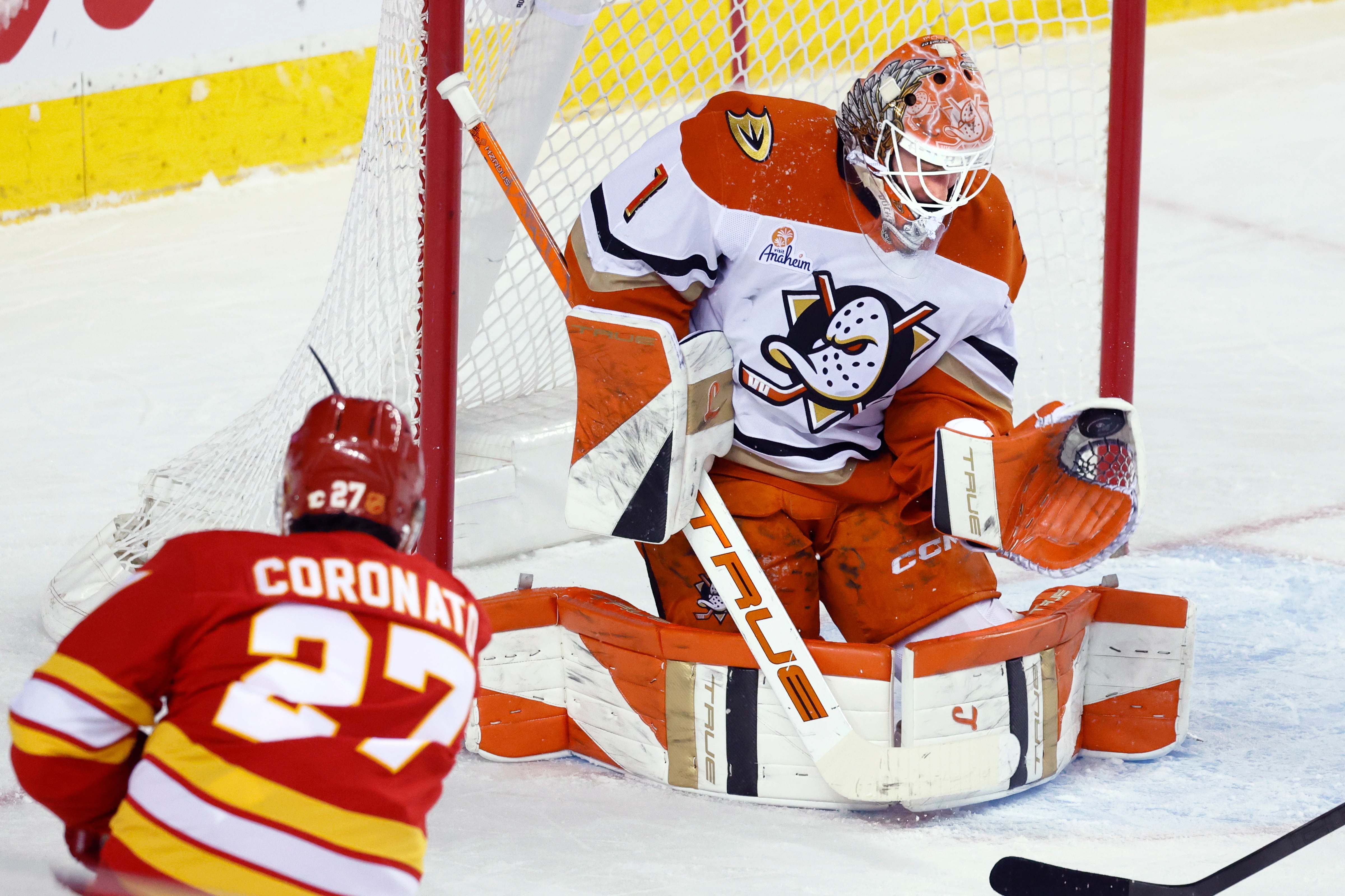 Ducks goalie Lukas Dostal (1) makes a save against Calgary...