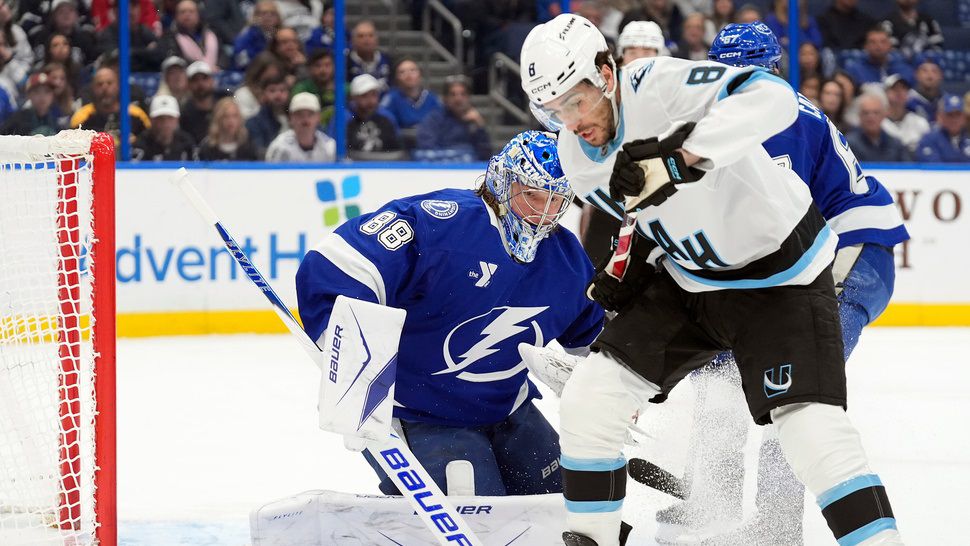 Tampa Bay Lightning goaltender Andrei Vasilevskiy (88) stops a shot by Utah Mammoth center Nick Schmaltz (8) during the first period of an NHL hockey game Monday, Jan. 26, 2026, in Tampa, Fla. (AP Photo/Chris O'Meara)