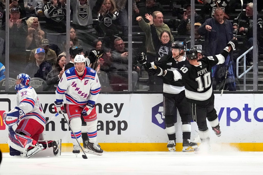 Los Angeles Kings right wing Adrian Kempe, second from right, celebrates his goal with right wing Corey Perry, right, as New York Rangers goaltender Jonathan Quick, left, and center J.T. Miller stand by during the first period of an NHL hockey game Tuesday, Jan. 20, 2026, in Los Angeles.