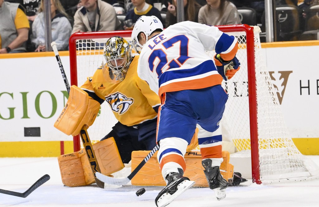 Juuse Saros makes a save on Anders Lee during the Islanders' 2-1 shootout to the Predators on Jan. 8, 2025 in Nashville.