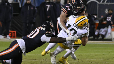 Jan 10, 2026; Chicago, IL, USA; Green Bay Packers quarterback Jordan Love (10) is sacked by. Chicago Bears defensive end Austin Booker (94) during the first half of an NFC Wild Card Round game at Soldier Field.