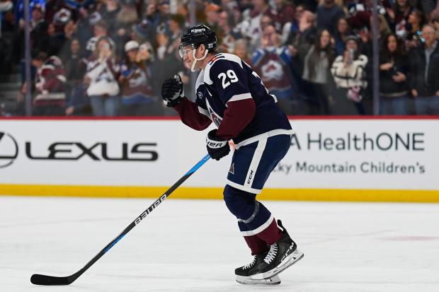 Colorado Avalanche center Nathan MacKinnon celebrates as he skates back to the team box after scoring a goal against the St. Louis Blues in the first period of an NHL hockey game Wednesday, Dec. 31, 2025, in Denver. (AP Photo/David Zalubowski)