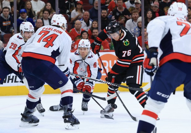 Blackhawks left wing Nick Lardis (76) is surrounded by Capitals defenders in the first period at the United Center on Jan. 9, 2026, in Chicago. (John J. Kim/Chicago Tribune)