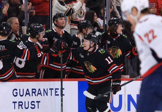 Blackhawks center Oliver Moore (11) celebrates with teammates after scoring a goal against the Capitals in the second period at the United Center on Jan. 9, 2026, in Chicago. (John J. Kim/Chicago Tribune)