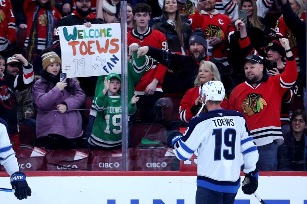 Winnipeg Jets center Jonathan Toews (19) interacts with fans while warming up before facing the Chicago Blackhawks at the United Center in Chicago on Jan. 19, 2026. (Chris Sweda/Chicago Tribune)