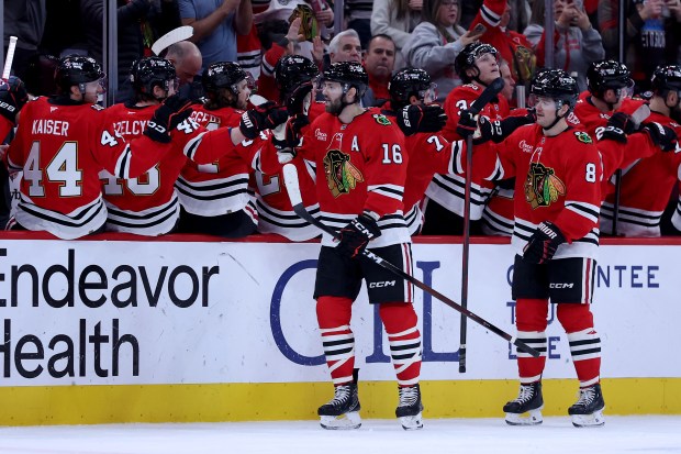 Chicago Blackhawks center Jason Dickinson (16) is congratulated by his teammates after scoring in the second period of a game against the Winnipeg Jets at the United Center in Chicago on Jan. 19, 2026. (Chris Sweda/Chicago Tribune)