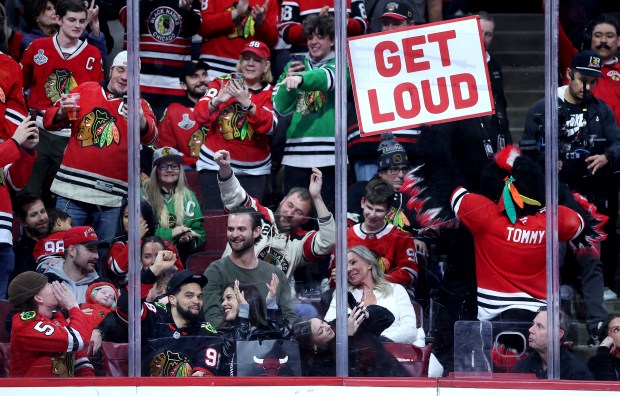 Chicago Bears quarterback Caleb Williams cheers with fans in the third period of a game between the Chicago Blackhawks and the Winnipeg Jets at the United Center in Chicago on Jan. 19, 2026. (Chris Sweda/Chicago Tribune)