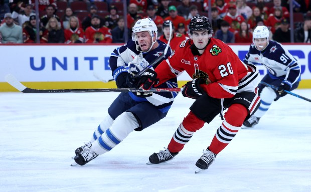 Winnipeg Jets center Jonathan Toews (19) and Chicago Blackhawks center Ryan Greene (20) battle in the third period of a game at the United Center in Chicago on Jan. 19, 2026. (Chris Sweda/Chicago Tribune)