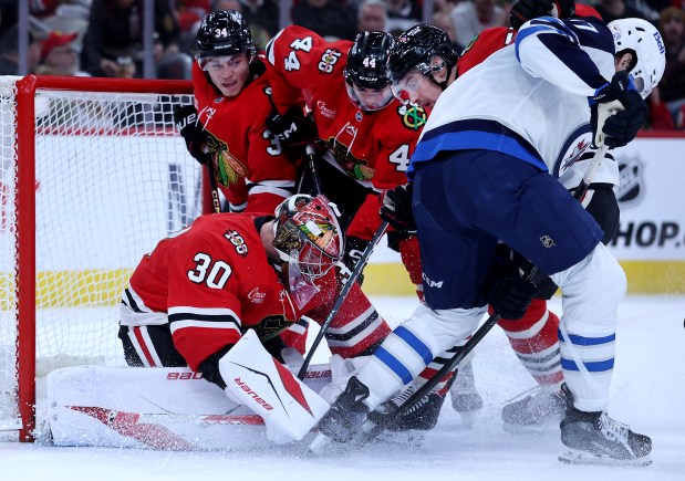 Chicago Blackhawks goaltender Spencer Knight (30) secures the puck in the second period of a game against the Winnipeg Jets at the United Center in Chicago on Jan. 19, 2026. (Chris Sweda/Chicago Tribune)