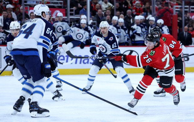 Chicago Blackhawks player Nick Lardis takes a shot in the first period of a game against the Winnipeg Jets at the United Center in Chicago on Jan. 19, 2026. (Chris Sweda/Chicago Tribune)