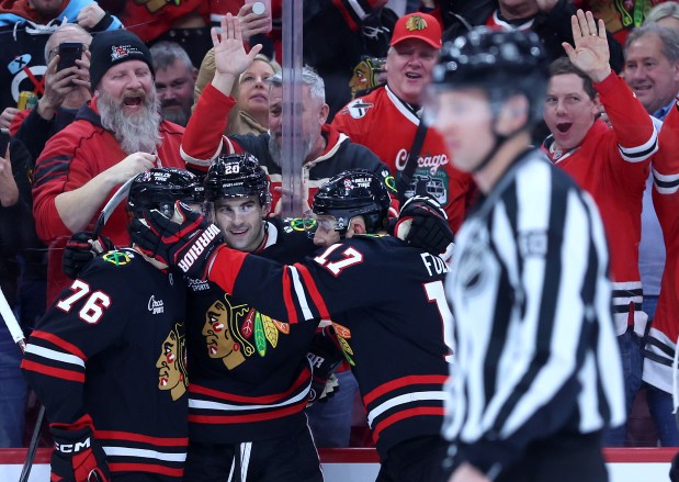 Chicago Blackhawks center Ryan Greene (20) celebrates with his teammates after scoring a goal in the first period of a game against the Tampa Bay Lightning at the United Center in Chicago on Jan. 23, 2026. (Chris Sweda/Chicago Tribune)