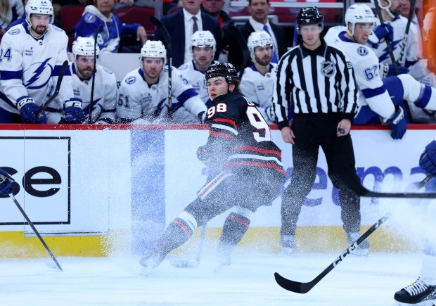 Chicago Blackhawks center Connor Bedard (98) makes a quick stop in front of the Tampa Bay Lightning bench in the first period of a game at the United Center in Chicago on Jan. 23, 2026. (Chris Sweda/Chicago Tribune)
