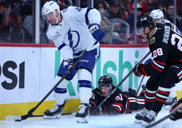Chicago Blackhawks center Frank Nazar (91) reaches for the puck while laying on the ice in the first period of a game against the Tampa Bay Lightning at the United Center in Chicago on Jan. 23, 2026. (Chris Sweda/Chicago Tribune)