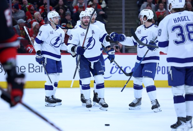 Tampa Bay Lightning right wing Nikita Kucherov (center) celebrates with is teammates after scoring a goal in the second period of a game against theChicago Blackhawks at the United Center in Chicago on Jan. 23, 2026. (Chris Sweda/Chicago Tribune)
