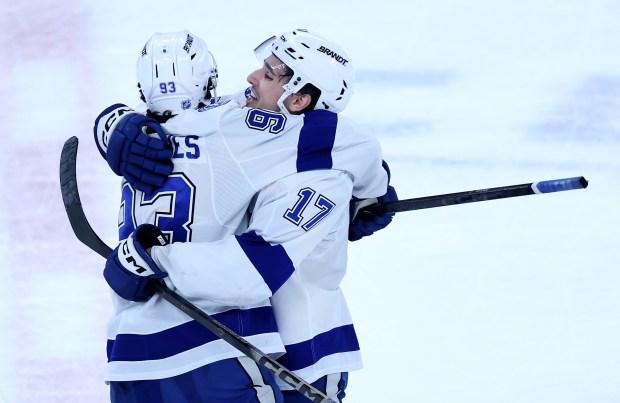 Tampa Bay Lightning centers Gage Goncalves (93) and Dominic James (17) embrace after James scored the game-winning goal during a shootout against the Chicago Blackhawks at the United Center in Chicago on Jan. 23, 2026. (Chris Sweda/Chicago Tribune)