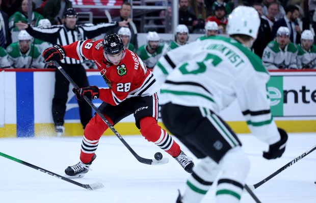 Chicago Blackhawks left wing Andre Burakovsky (28) tries to control the puck in the first period of a game against the Dallas Stars at the United Center in Chicago on Jan. 1, 2026. (Chris Sweda/Chicago Tribune)