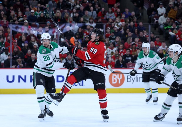 Chicago Blackhawks left wing Tyler Bertuzzi (59) follows through on a shot beside Dallas Stars defenseman Alexander Petrovic (28) in the first period of a game at the United Center in Chicago on Jan. 1, 2026. (Chris Sweda/Chicago Tribune)