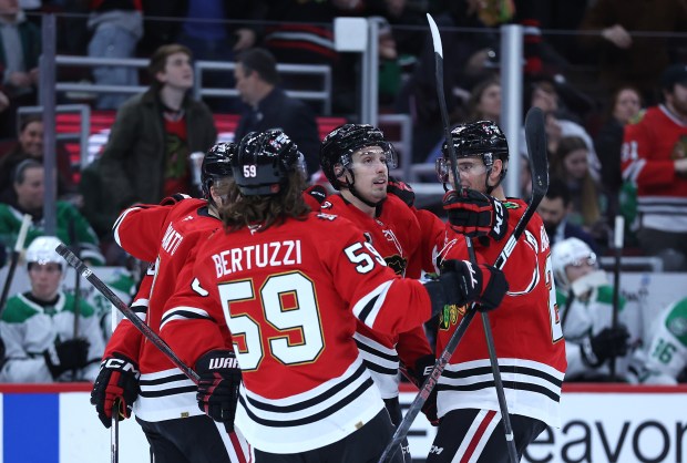Chicago Blackhawks defenseman Artyom Levshunov (center) celebrates with his teammates after scoring a goal in the first period of a game against the Dallas Stars at the United Center in Chicago on Jan. 1, 2026. (Chris Sweda/Chicago Tribune)