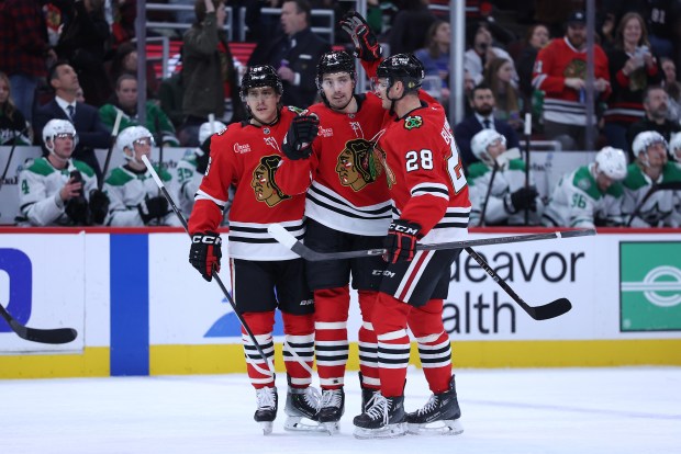 Chicago Blackhawks defenseman Artyom Levshunov (center) celebrates with his teammates after scoring a goal in the first period of a game against the Dallas Stars at the United Center in Chicago on Jan. 1, 2026. (Chris Sweda/Chicago Tribune)