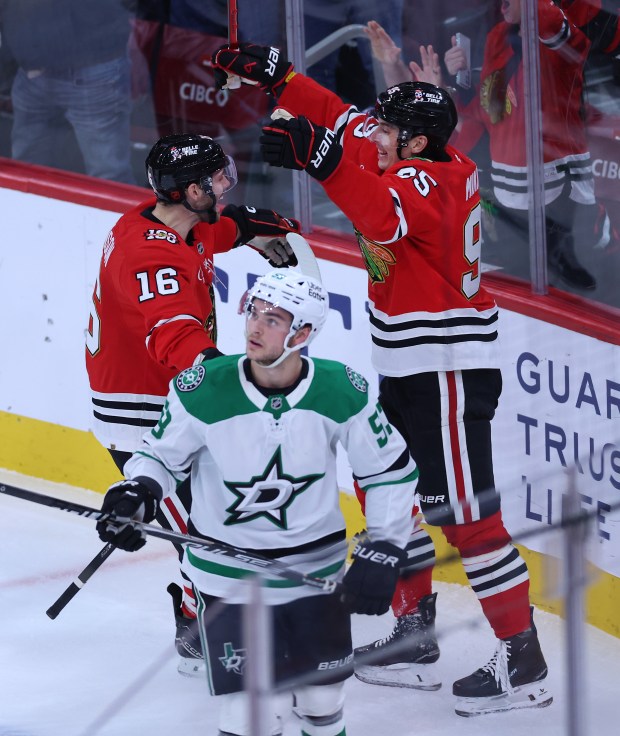 Chicago Blackhawks right wing Ilya Mikheyev (95) and center Jason Dickinson (16) celebrate after Mikheyev scored a goal in the second period of a game against the Dallas Stars at the United Center in Chicago on Jan. 1, 2026. (Chris Sweda/Chicago Tribune)