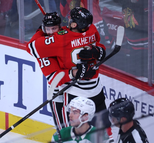 Chicago Blackhawks right wing Ilya Mikheyev (95) and center Jason Dickinson (16) celebrate after Mikheyev scored a goal in the second period of a game against the Dallas Stars at the United Center in Chicago on Jan. 1, 2026. (Chris Sweda/Chicago Tribune)