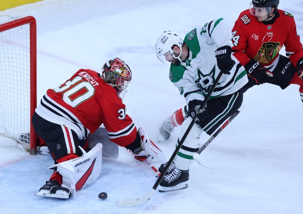 Chicago Blackhawks goaltender Spencer Knight (30) defends as Dallas Stars center Colin Blackwell (15) is unable to score in the second period of a game at the United Center in Chicago on Jan. 1, 2026. (Chris Sweda/Chicago Tribune)