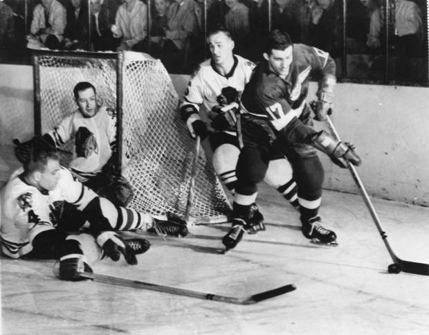 Action from the 1961 Stanley Cup Finals game on April 16, 1961. Allan Johnson [17] of the Detroit Red Wings controls the puck in the first period of Saturday's Stanley Cup game in Detroit. Chicago defenseman Elmer Vasko [4] and goalie Glenn Hall move to block the goal, while Reg Fleming [6] of Chicago moves in behind Johnson. The Blackhawks defeated the Detroit Red Wings 4 games to 2. Chicago Tribune photo. B58450219Z.1 (hockey pro) HIST, BLACK HAWKS
